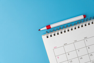 Top down view of a monthly calendar page with a red marker pen. Scheduling, planning, and time management concepts. Copy space for text © izzuan
