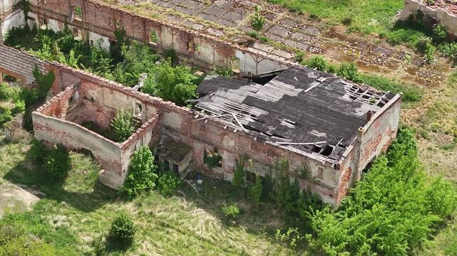 Aerial ruins communist state farm Poland circle 2. Soviet State Agricultural Farm or State-Owned Farm. Collective agriculture employment and housing. Fall of Russia communism socialism farming.