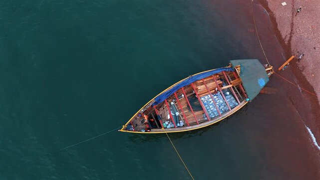 Fisherman on a wooden dhow in Lake Tanganyika, capturing traditional fishing and lakeside life in Tanzania.