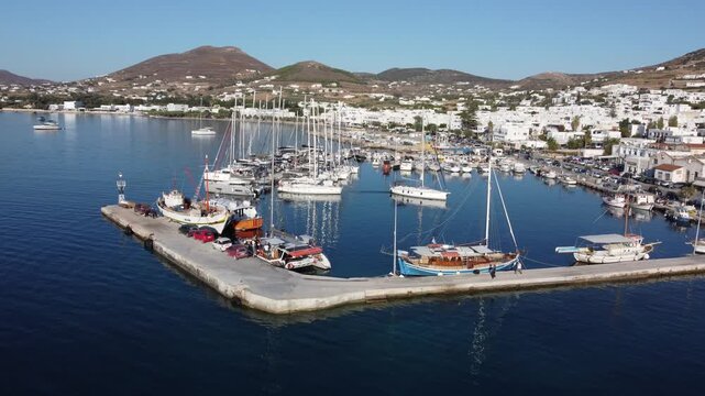 Bay of Piso Livadi in Paros, Docked boats and yachts, Aegean sea, Drone shot