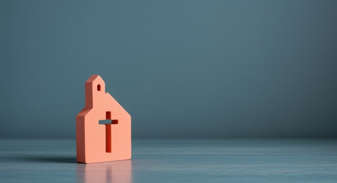 Small wooden church block with cross cutout standing on a neutral surface for religious community branding, faith-based app hero images and spiritual storytelling