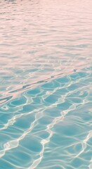 Fototapeta premium Swimming pool water surface with ripples and pink sunset reflections for summer lifestyle brand, resort advertising and luxury spa background under natural light