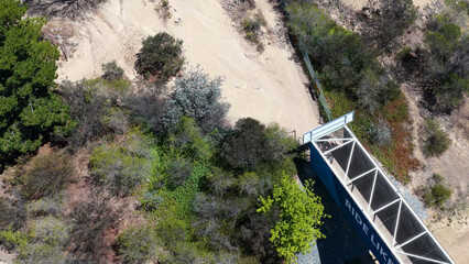 Obraz premium Aerial View of a Blue Metal Bridge and Dirt Trail in Canberra