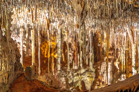 Detailed view of the stalactites and stalagmites rock formations inside Grutas da Moeda cave in Fatima, Portugal. The cave is a popular tourist attraction known for its beauty.