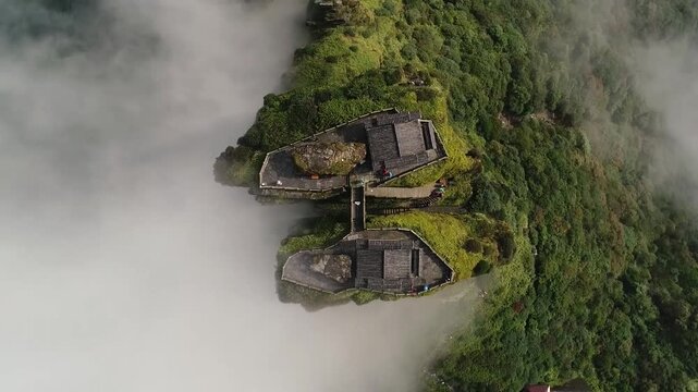 An aerial view of the mysterious fanjing mountain temple complex surrounded by thick white mist