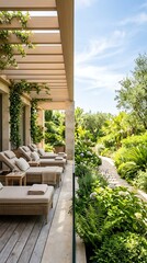 Obraz premium Luxury resort lounge area with comfortable sunbeds and lush green garden on a sunny day, perfect for relaxation and vacation.