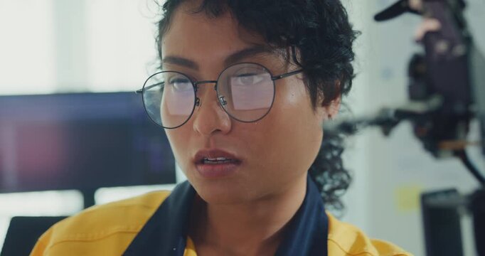 Close-up young Black female engineer coding AI robot arm in modern laboratory. Robotics, artificial intelligence, technology, stem, future, innovation, diversity, automation, machine learning concept.