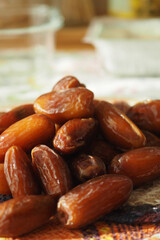 Fototapeta premium Dates are stacked on a table with a blurred background