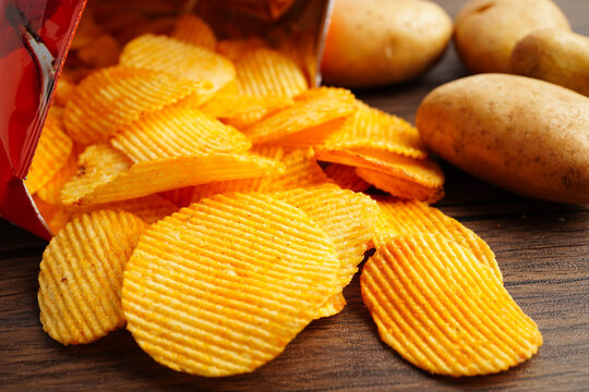 Potato chips in open bag, delicious BBQ seasoning spicy for crips, thin slice deep fried snack fast food.