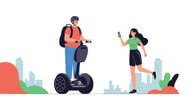 Young man riding a segway while a woman takes his picture with a smartphone in a modern city park environment.