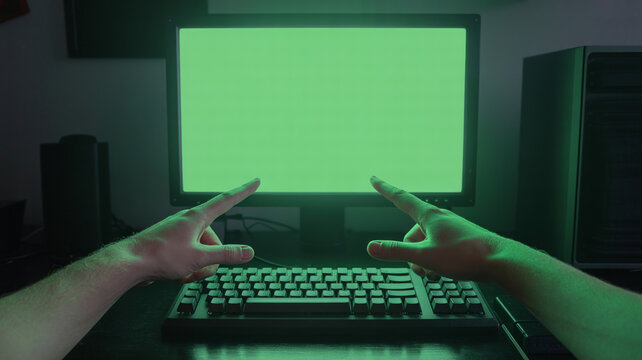 Hands coding on mechanical keyboard with green screen glow, tech photography