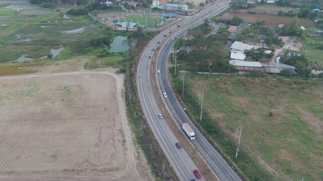 Slow motion Aerial view of scenic landscape of rural countrydside traffic 