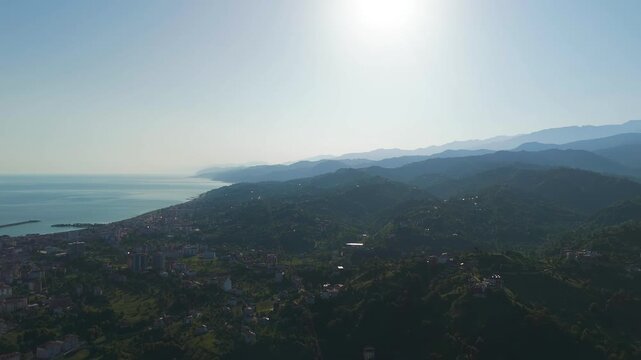 Ardeshen, Turkey. Firtina River Valley, sweeping aerial panorama over lush green hills, winding river, and distant Kackar Mountains under bright morning sun. Aerial View, MasterShots, Panorama