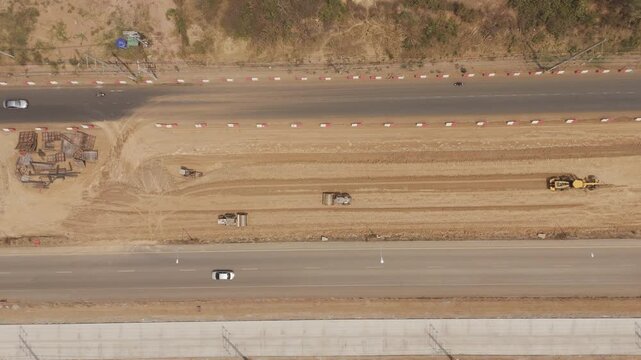 Drone footage a construction working tractor is refining the soil in preparation for laying asphalt The process of making a highway