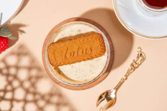 halla lotus served on the table with a small bowl and a glass of tea and a gold spoon.