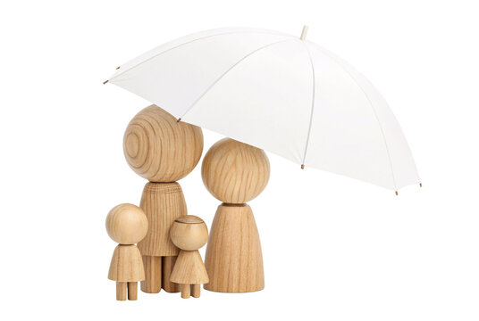 Two tall and two small rounded wooden peg dolls grouped together under a white umbrella, family protection concept photo.