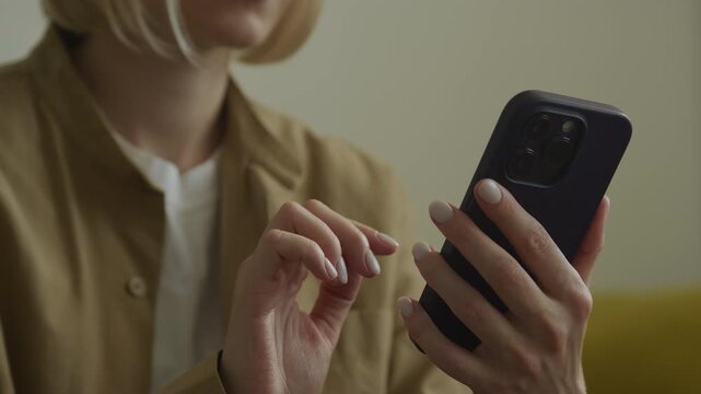 Unrecognizable Woman Using Smartphone Indoors