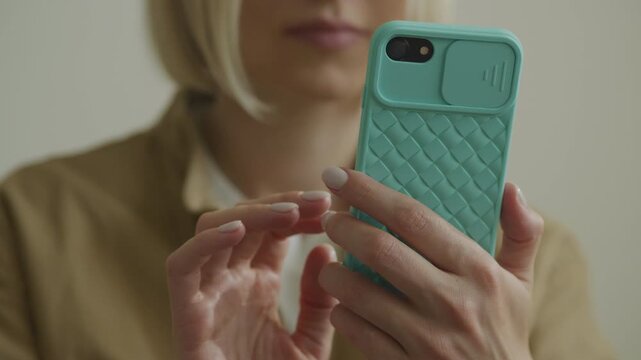Unrecognizable Woman Scrolling on Smartphone