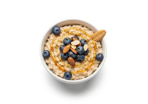 Hearty oatmeal bowl topped with fresh berries and nuts white background