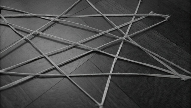 Chaotic montage of vintage newspaper clippings concept. Artistic rope patterns create a unique geometric design on floor.