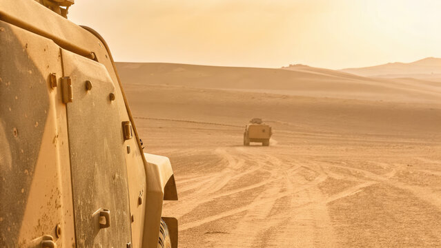 Military convoy crossing deserted wasteland concept. Military vehicles navigating through a desert landscape at sunset.