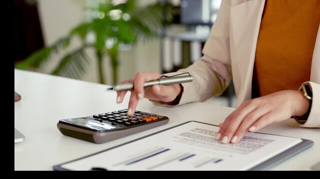 Close up Business woman hand doing finances and calculate on desk about cost . Woman working on desk with using calculator, finance accounting. Business finance accounting banking concept.