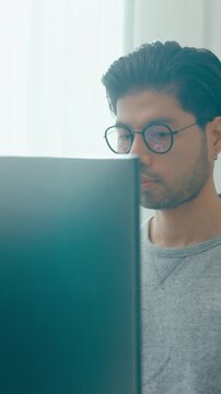 Vertical Screen : Young adult Asia male freelance eyeglasses typing write prompt AI bot app smart program nomad, video game, terminal with coding, user interface, big data center on desktop computer.
