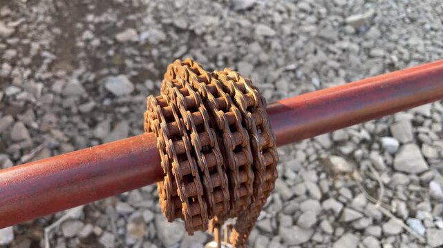 Rusty Bicycle Gear Cassette Mounted on Metal Pipe Outdoors