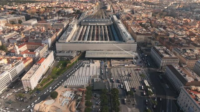 Roma Termini railway station with tracks and surrounding city buildings in Rome, aerial