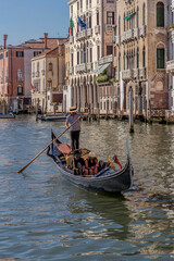Young honeymoon couple visits the Grand Canal on a traditional gondola in Venice, Italy © Marco Taliani