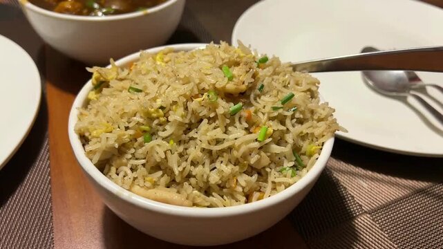 A vibrant, close-up shot of authentic Kolkata-style mixed fried rice, prepared in the iconic wok-tossed Indian-Chinese style unique to Kolkata's historic Chinatown, India.