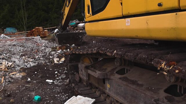 Excavator Continuous Tracks Moving over Rubble on a Demolition Site