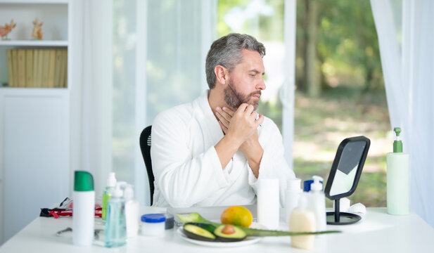 Facial cream for male skin. Man applying facial cream for a beauty skincare routine. Facial beauty and rejuvenation for male. Facial morning routine. Man skincare concept.
