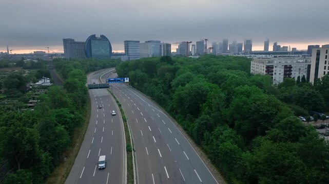 Descending dolly flight over a street in Frankfurt am Main, shrouded in morning autumn fog. Germany, Skyline, New skyscrapers City canyon in the light of sunset or sunrise. The shot has a continuation