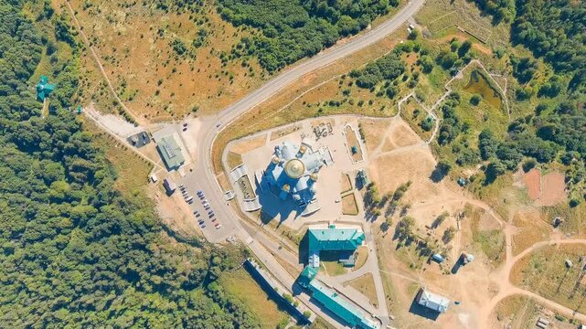 Russia, Perm region. Belogorsk St. Nicholas Missionary Monastery, Drone footage of the neo-Byzantine Holy Cross Cathedral with golden domes atop Belaya Gora, surrounded by dense Ural forest. Drone fo