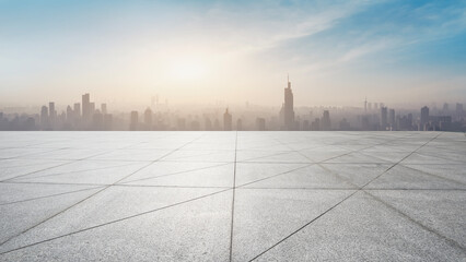 Empty Rooftop Plaza Overlooking Hazy Modern City Skyline © zhouyilu
