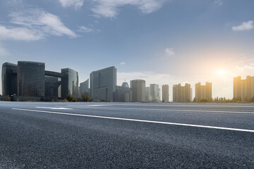Asphalt Highway With Modern City Skyline At Sunrise © zhouyilu