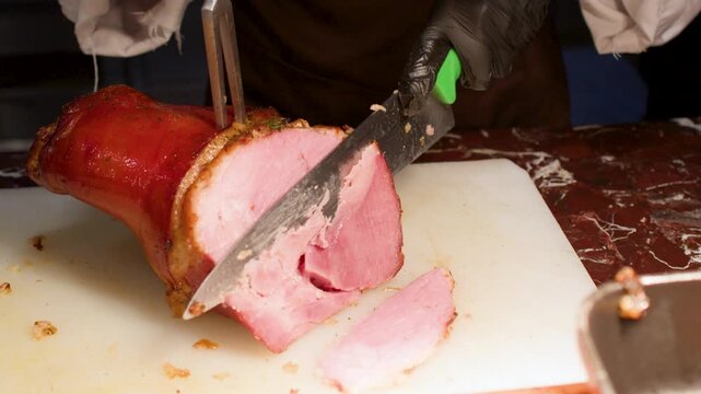 Professional Chef Slicing Roasted Ham on Cutting Board at Buffet
