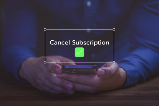 Hand holding smartphone to cancel online service subscription. Business user using internet technology to unsubscribe.