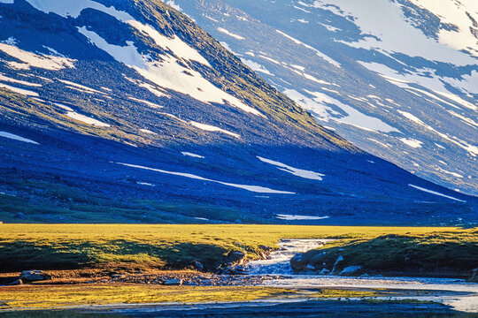 River in a mountain valley with steep mountainsides