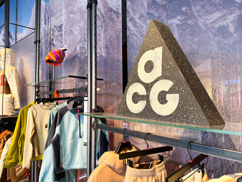 Shanghai, China - November 27, 2025: Nike ACG Logo Close Up with Outdoor Clothing Display