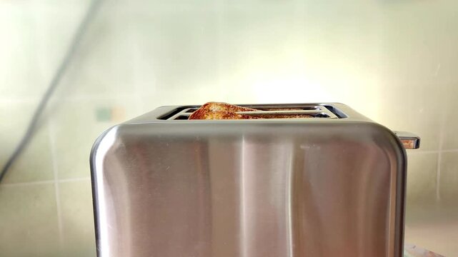 toasts jumping out of a metal toaster