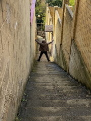 Fototapeta premium Man stands at top of steep concrete stairs