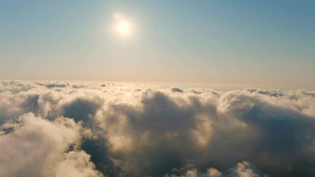 Istanbul, Turkey. Aerial flight above dense cumulus cloud formations, the Black Sea visible through breaks in the cloud cover, warm sunset light illuminating the sky. Drone footage