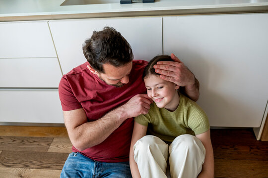 Parent providing mental health support to teenage child facing challenges at home.