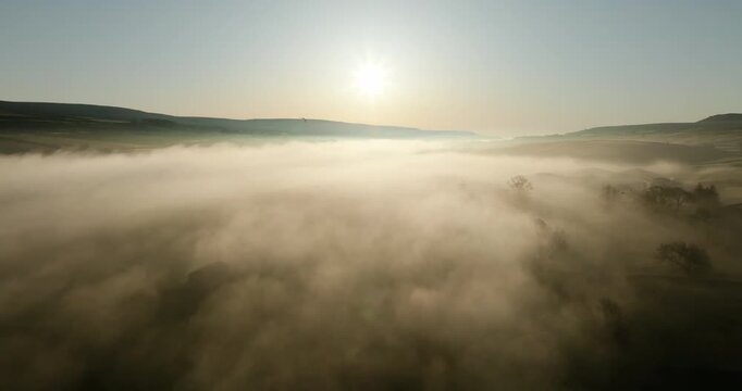 Sunrise over foggy valley and calm river