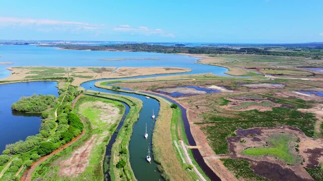 Aerial shot of meandering River Frome through Salt Marsh and Reed beds near Poole, UK