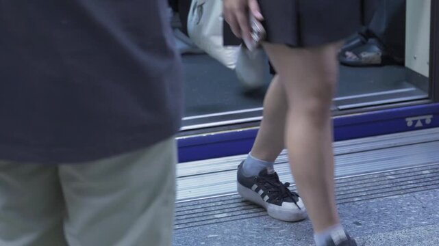 low angle view point to ground floor platform of train station while passenger get off and get into subway train commuter transportation ready for departure, subway transportation in rush hour