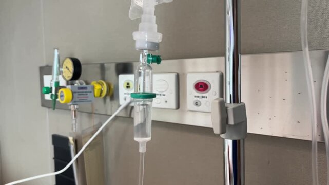 A close-up view of an IV drip and drip chamber containing lactated Ringer's solution in a hospital. Medical equipment for patient hydration and treatment, symbolizing patient health care.