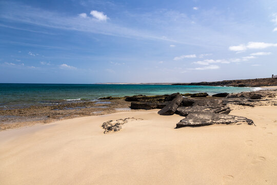The beautiful white sandy beach with the unique sandscaped boulders on the waterfront of the Atlantic ocean near the village of Pedra de Luma on the island of Sal in Cape Verde. This kind of deserted 